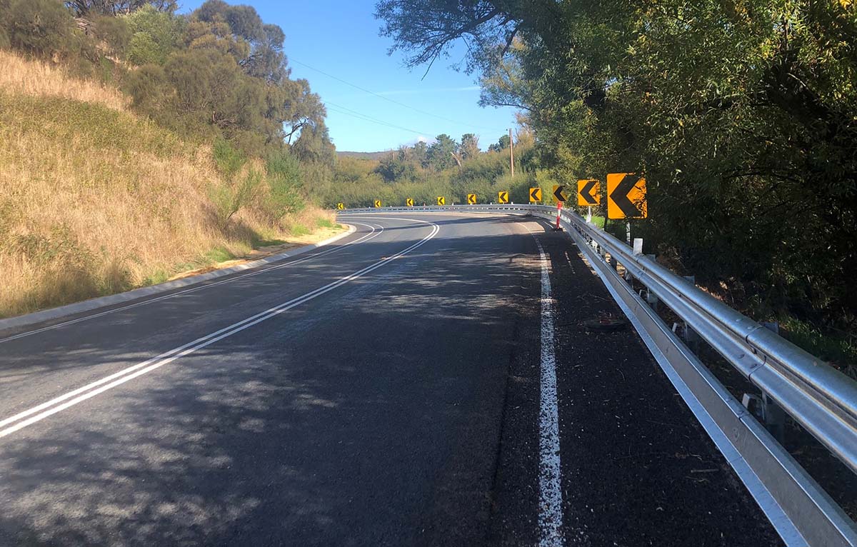 A motorocycle barrier rail along the side of a road.